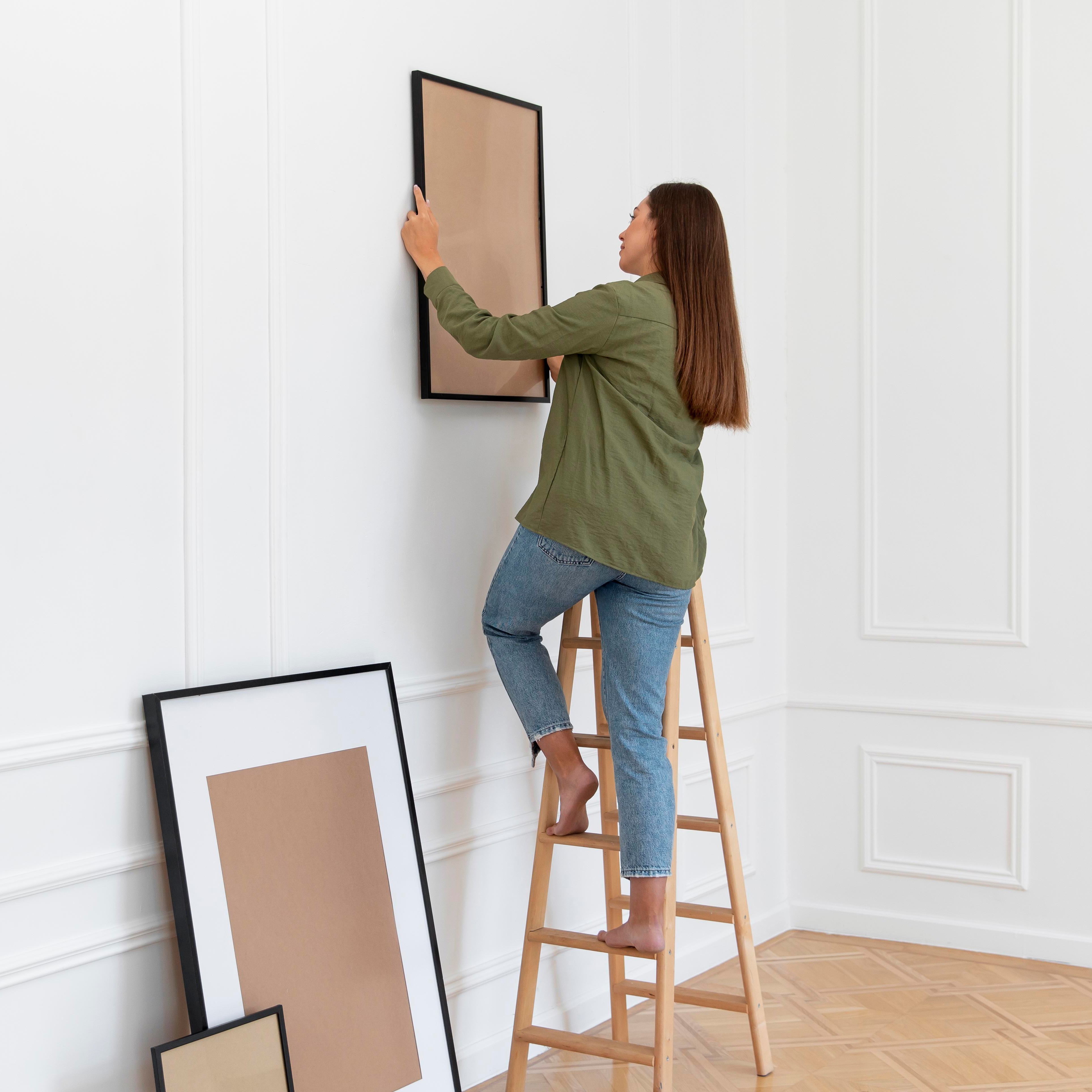 full-shot-woman-holding-frame.jpg